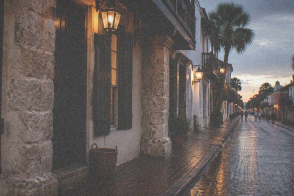 Lantern-lit historic St. George Street storefronts at dusk