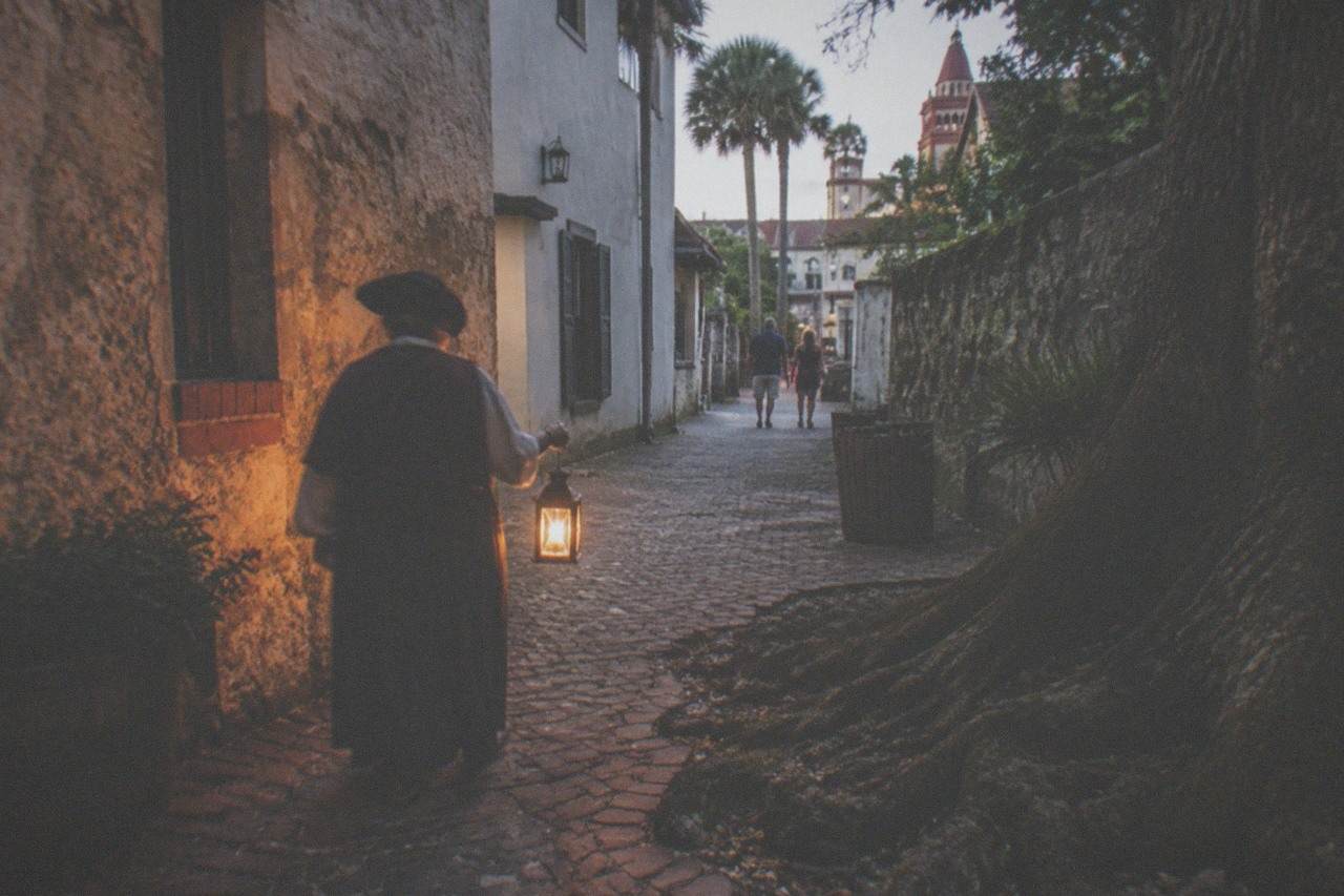 Lantern light on a narrow historic street in old St. Augustine at dusk
