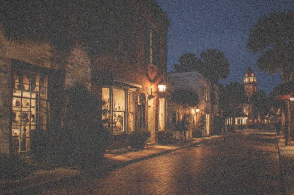 St. George Street at night with lit storefronts and colonial-era brick buildings