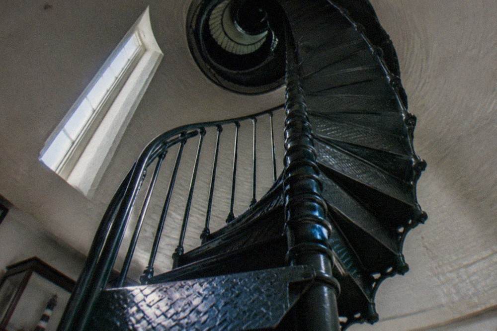 Spiral staircase inside a lighthouse tower seen from below