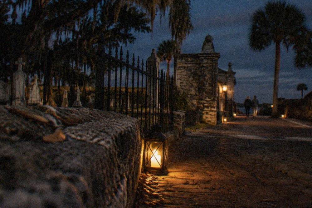 Lantern light glowing on a dark brick lane in St. Augustine