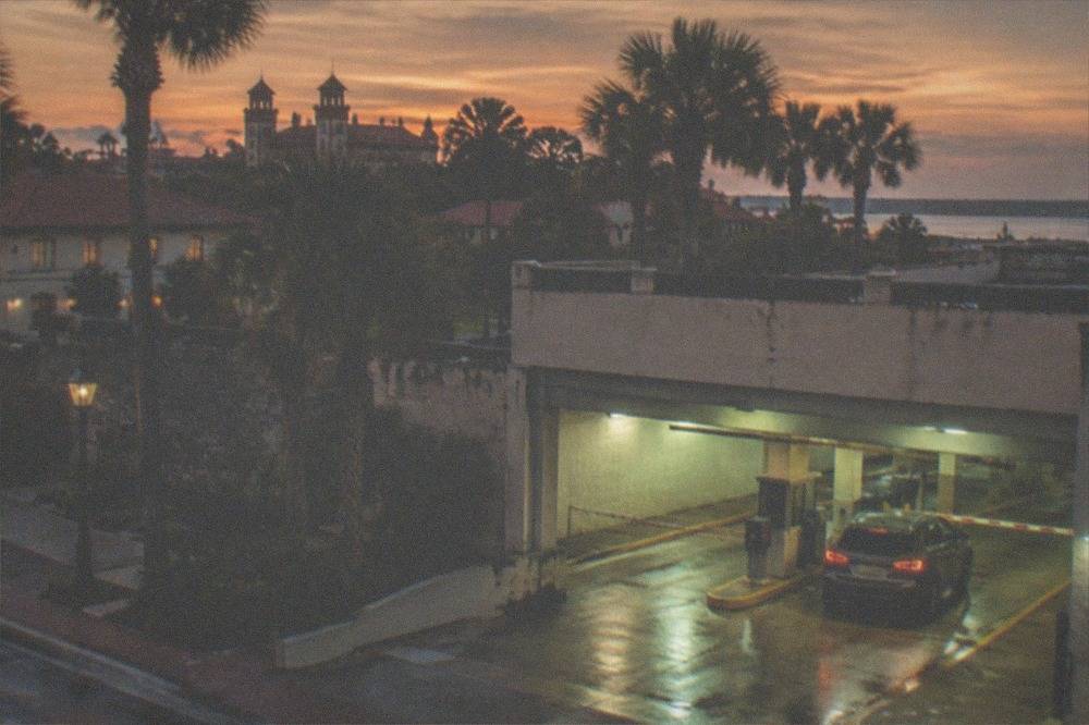 A downtown parking garage entrance lit up at dusk