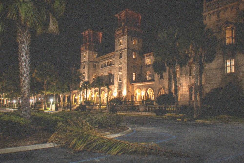 A historic museum building lit against a night sky in St. Augustine
