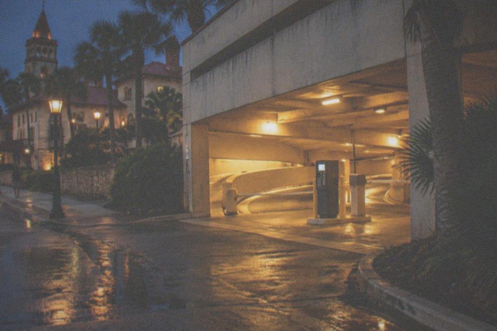 A downtown St. Augustine parking garage entrance lit warmly at night