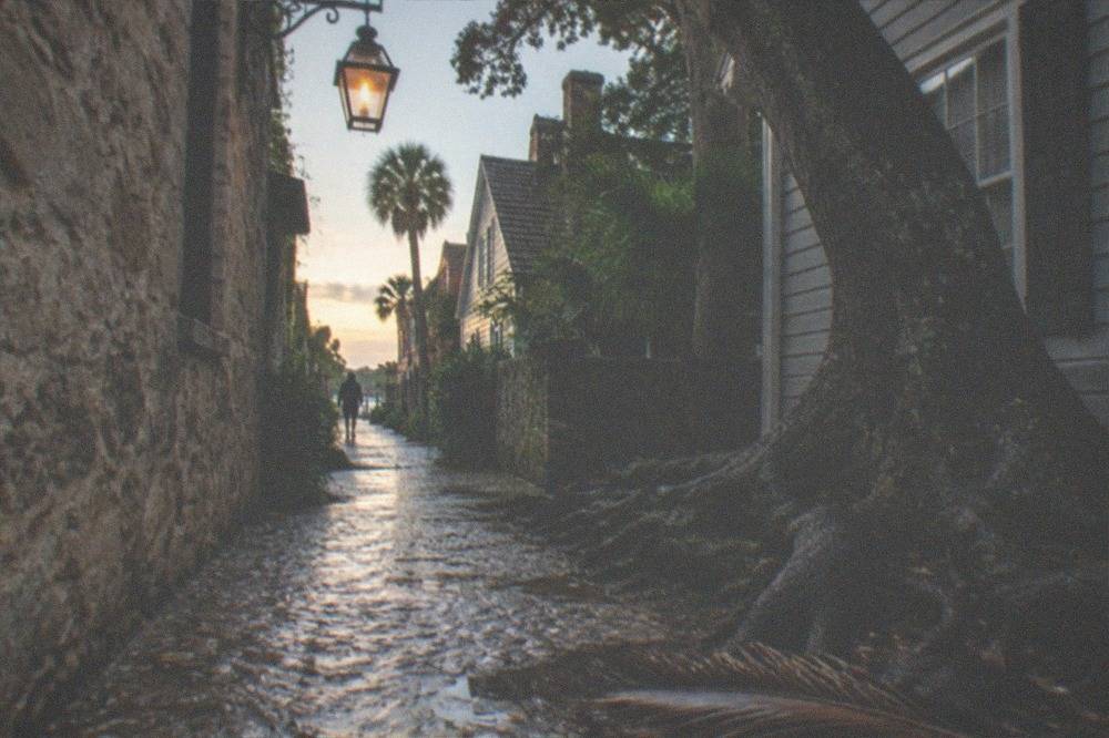 A dark historic alley in St. Augustine with a single hanging lantern