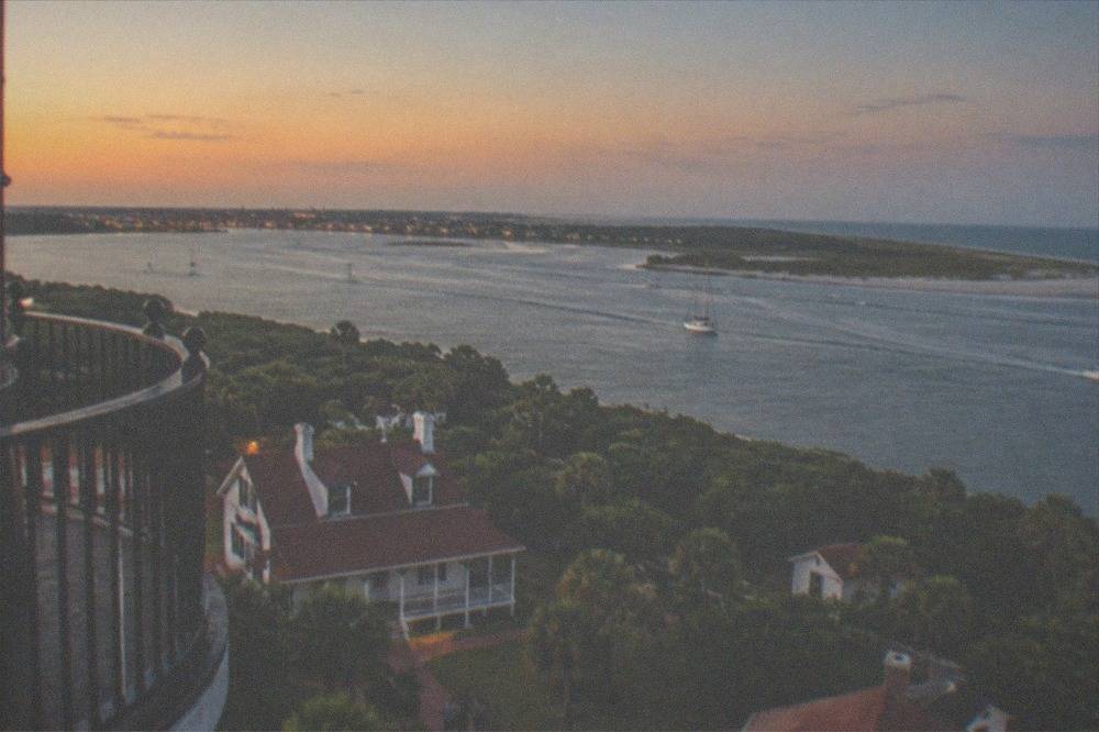 View from the lighthouse gallery over the inlet, the shoreline and the distant city skyline