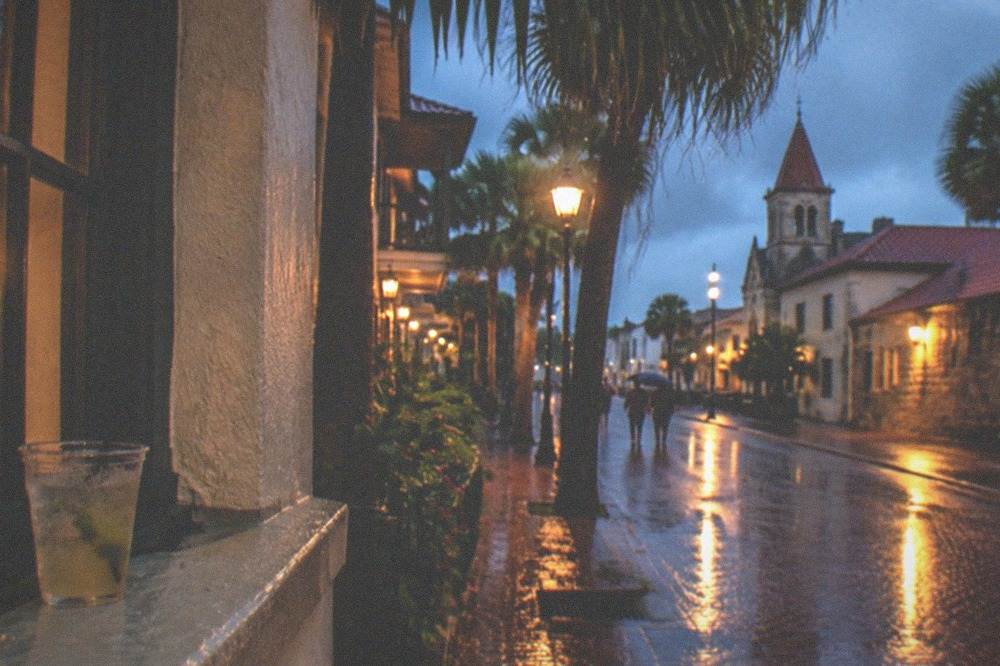 Downtown historic street with brick buildings and warm street lamps at night
